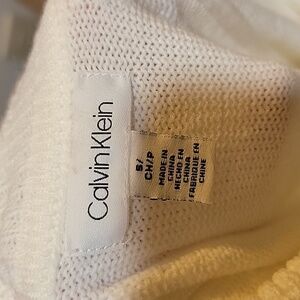 White Calvin Klein turtle neck.